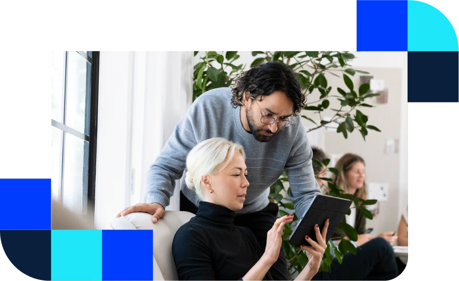 A man and a woman looking at a mobile device