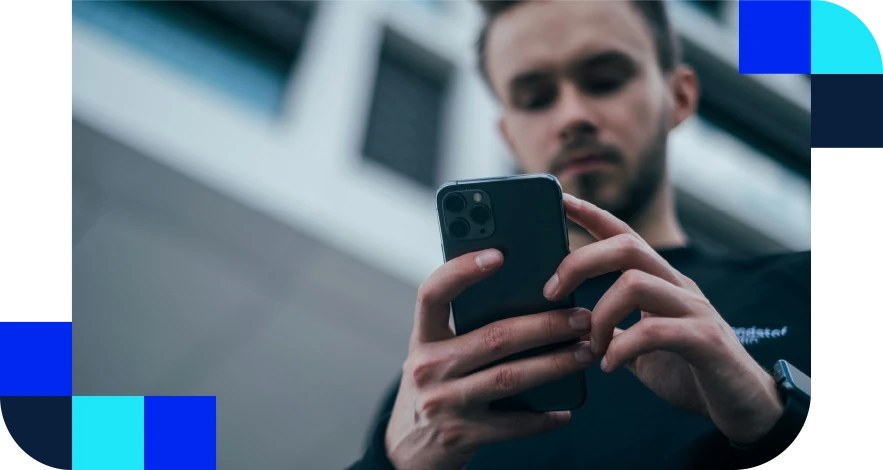 Photo of man looking at his mobile phone